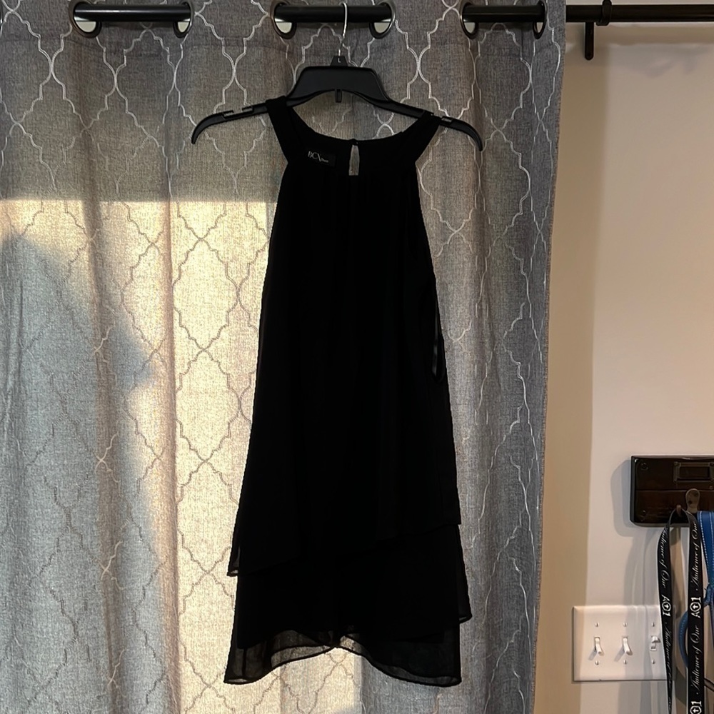 XS little black dress, knee length, sleeveless.